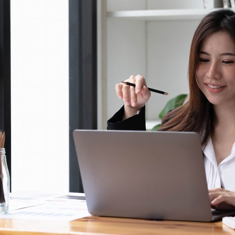 business-asian-woman-using-laptop-for-do-math-finance-on-wooden-desk-in-office-tax-accounting.jpg